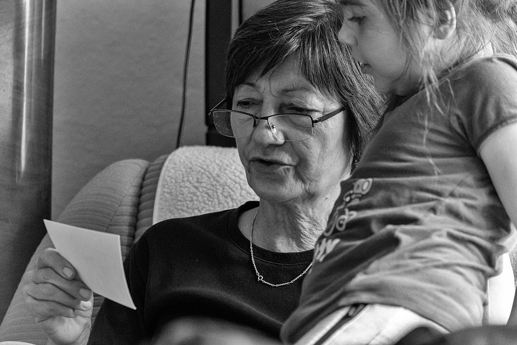 An image of a grandmother reading out a letter to her granddaughter