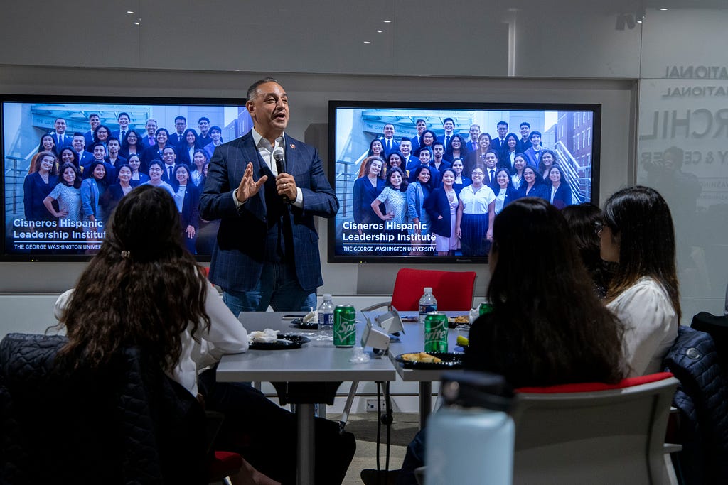 Scholars listen attentively as the Congressman shares his story