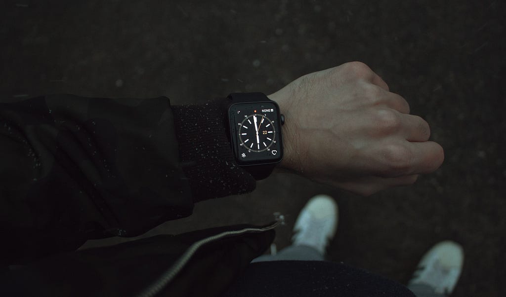 Image of a person’s wrist. They are wearing a smart watch showing a compass.