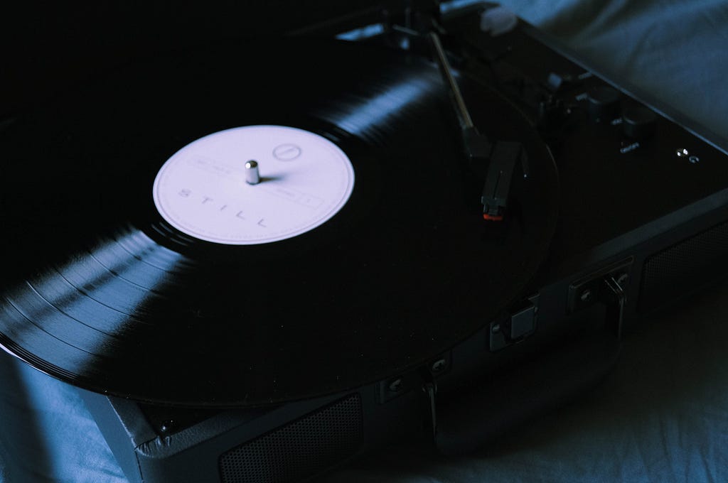 Black Vinyl Record Player With Vinyl Record.