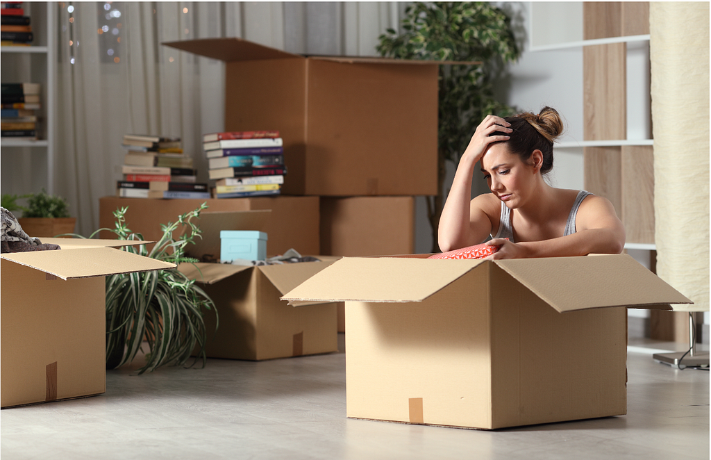 Female packing belongings into boxes