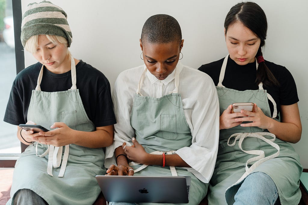 A group of phone users looking glued to their phone screens