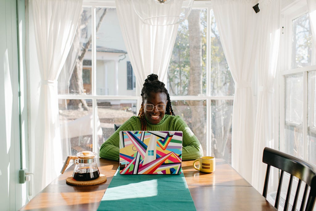 Service based professional black lady working on her laptop