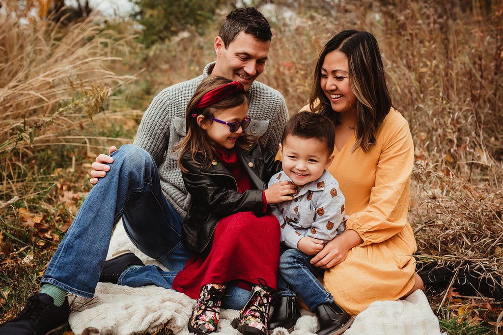 A photograph of Amanda with her husband and two kids.