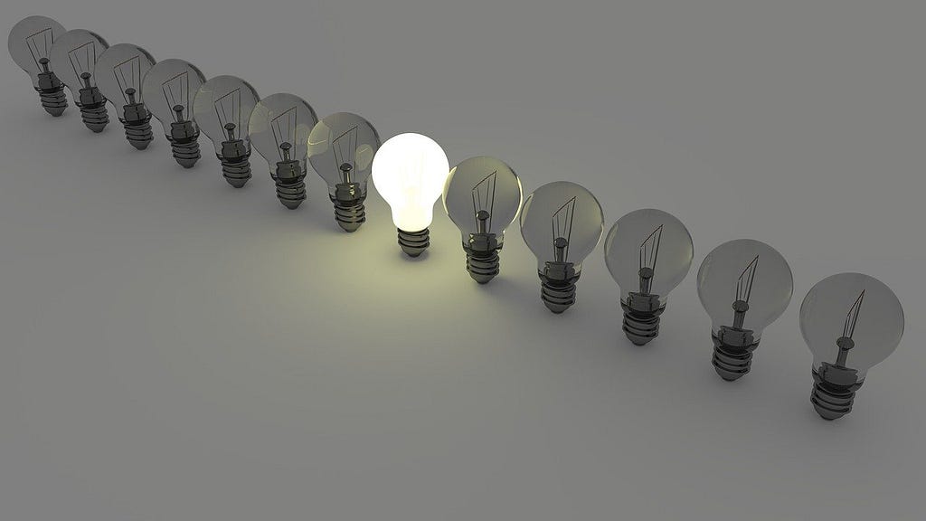 Image showing a line of light bulbs with only the center one lit.