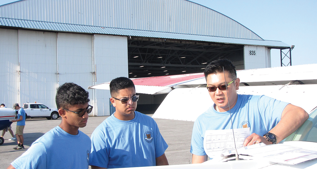 A flight instructor talking to to student pilots.