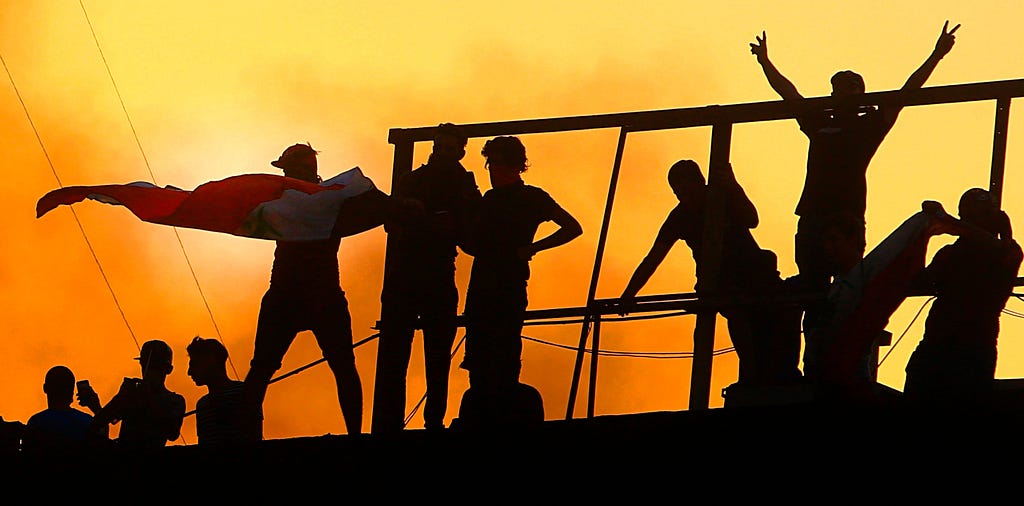 Protesters stormed and burned a government building in Basra, Iraq, demanding better public services amid a prolonged heat wave, September 7, 2018. Photo by Nabil Al-Jurani/AP