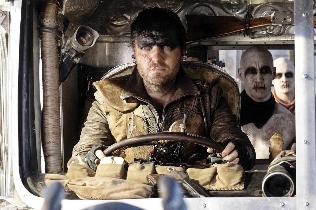 A screenshot of Tom Burke as Praetorian Jack driving a war rig.