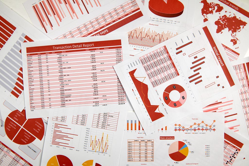 A mess of printed pages with lots of data and graphs.