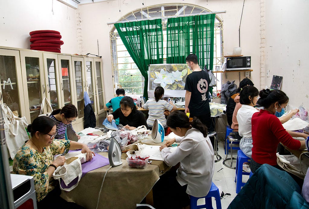 A group of people at work designing artwork and crafts.