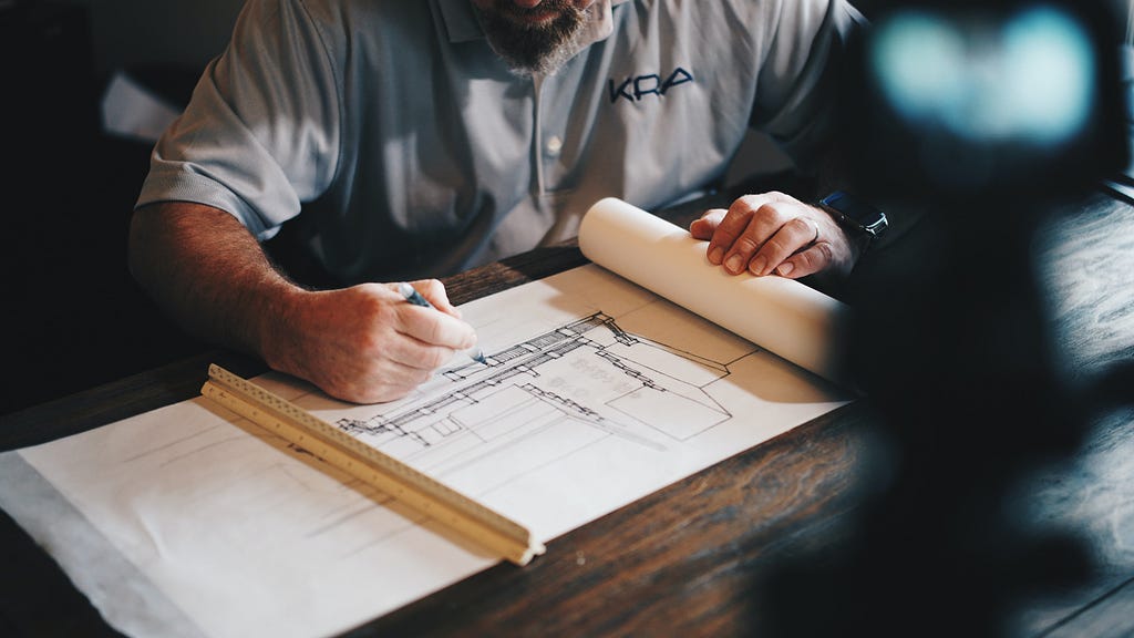 Man drawing blueprint