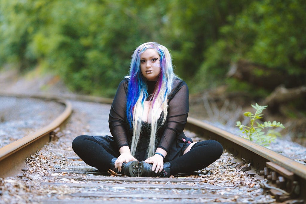 bbw model posing on railway line