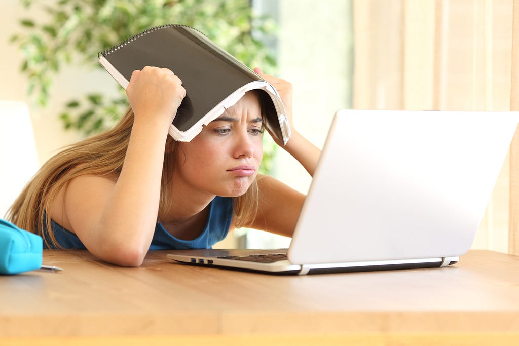 Frustrated student looking at laptop computer