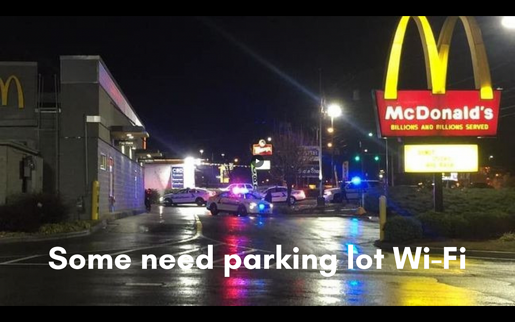 Some need parking lot Wi-Fi. Picture of police cars with their lights flashing in a dark McDonald's parking lot.