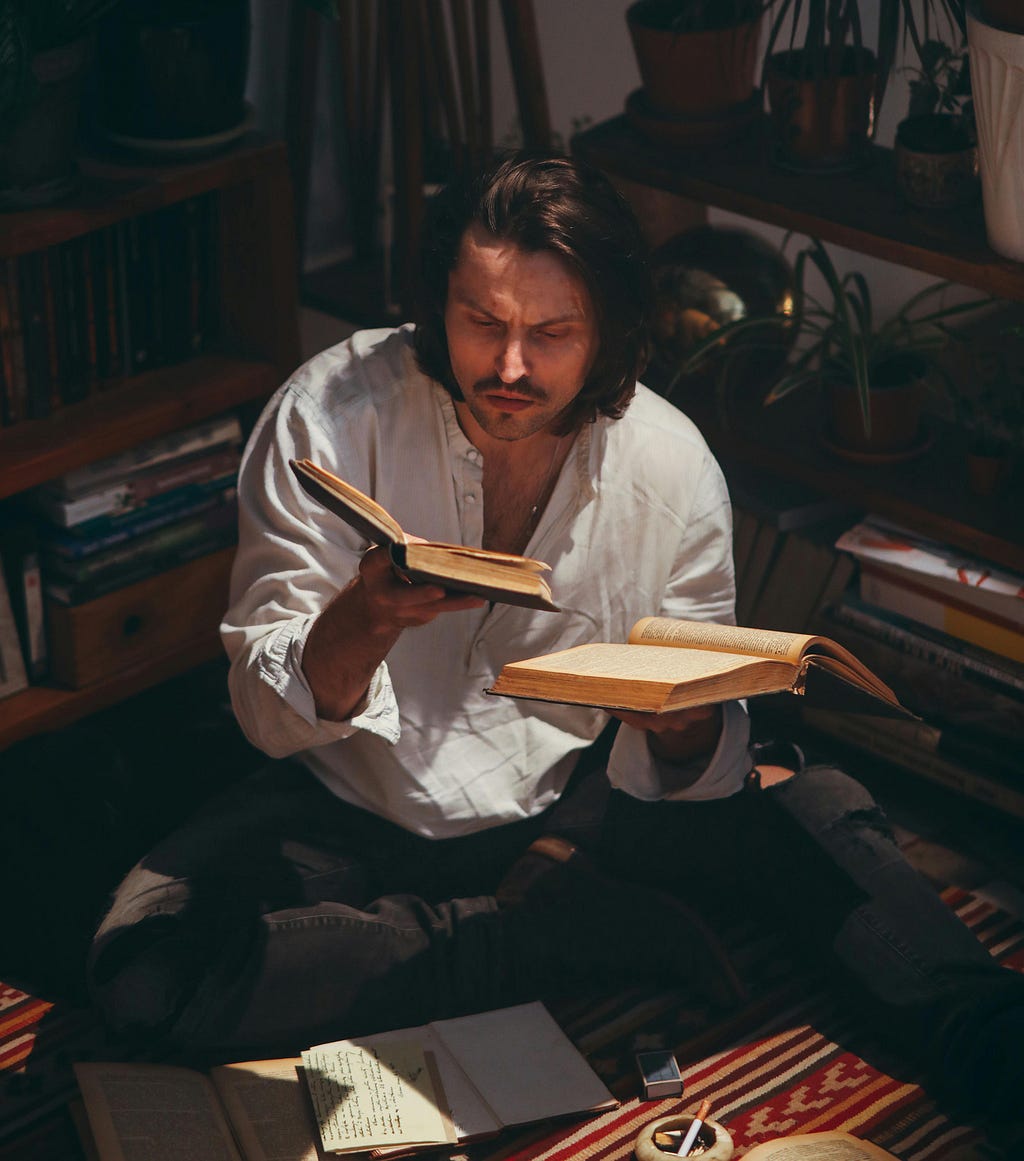 man searching ancient books for meaning of mysteries