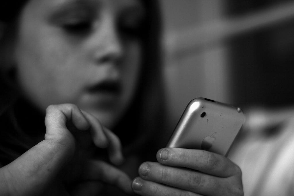 Young girl dialing a cell phone