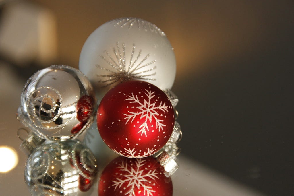 Red and silver Christmas baubles on a table