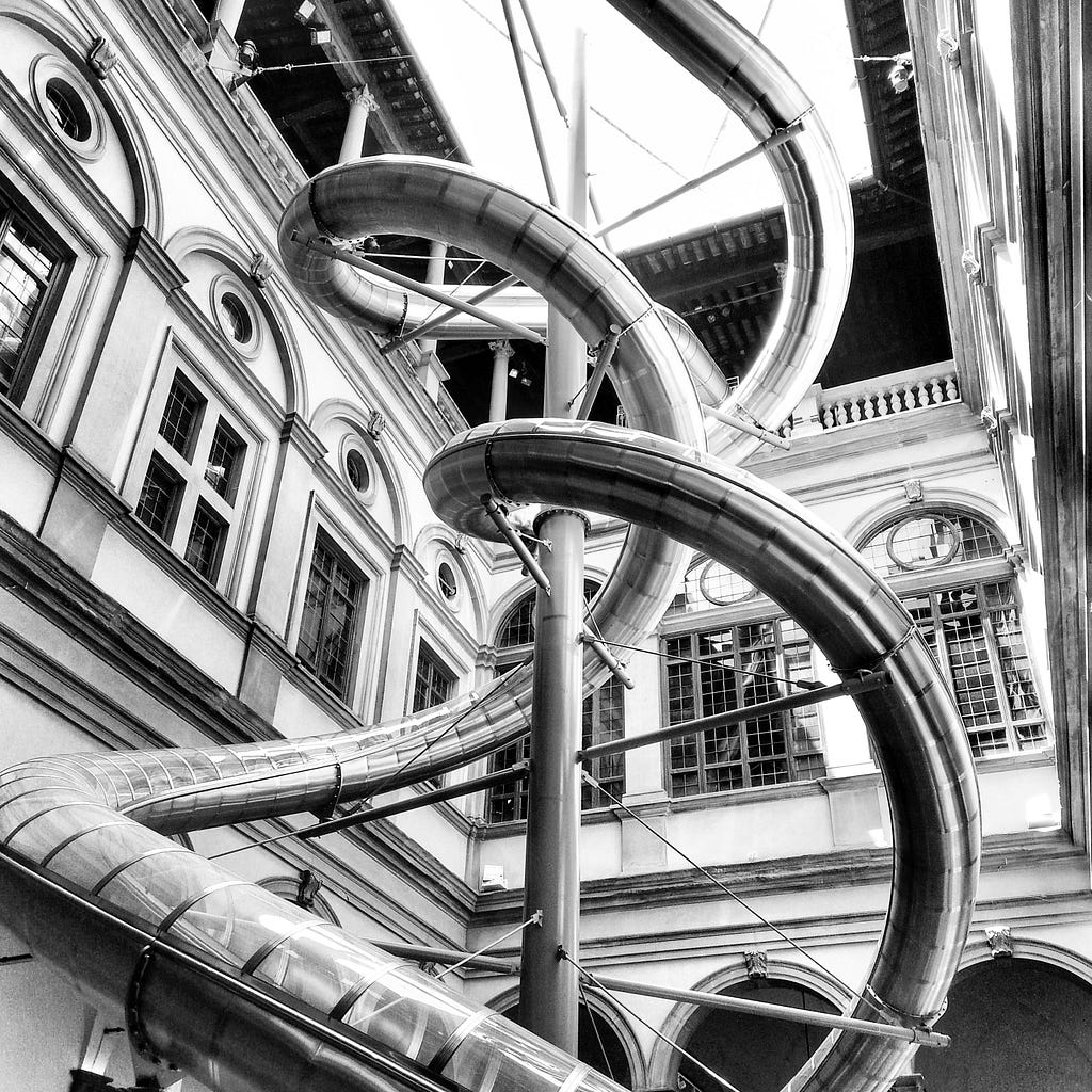 Installation of Carsten Höller in Palazzo Strozzi. The picture shows a modern slide right in the middle of the more than 500 year old Palazzo which was installed as part of “The Florence Experiment” in 2018
