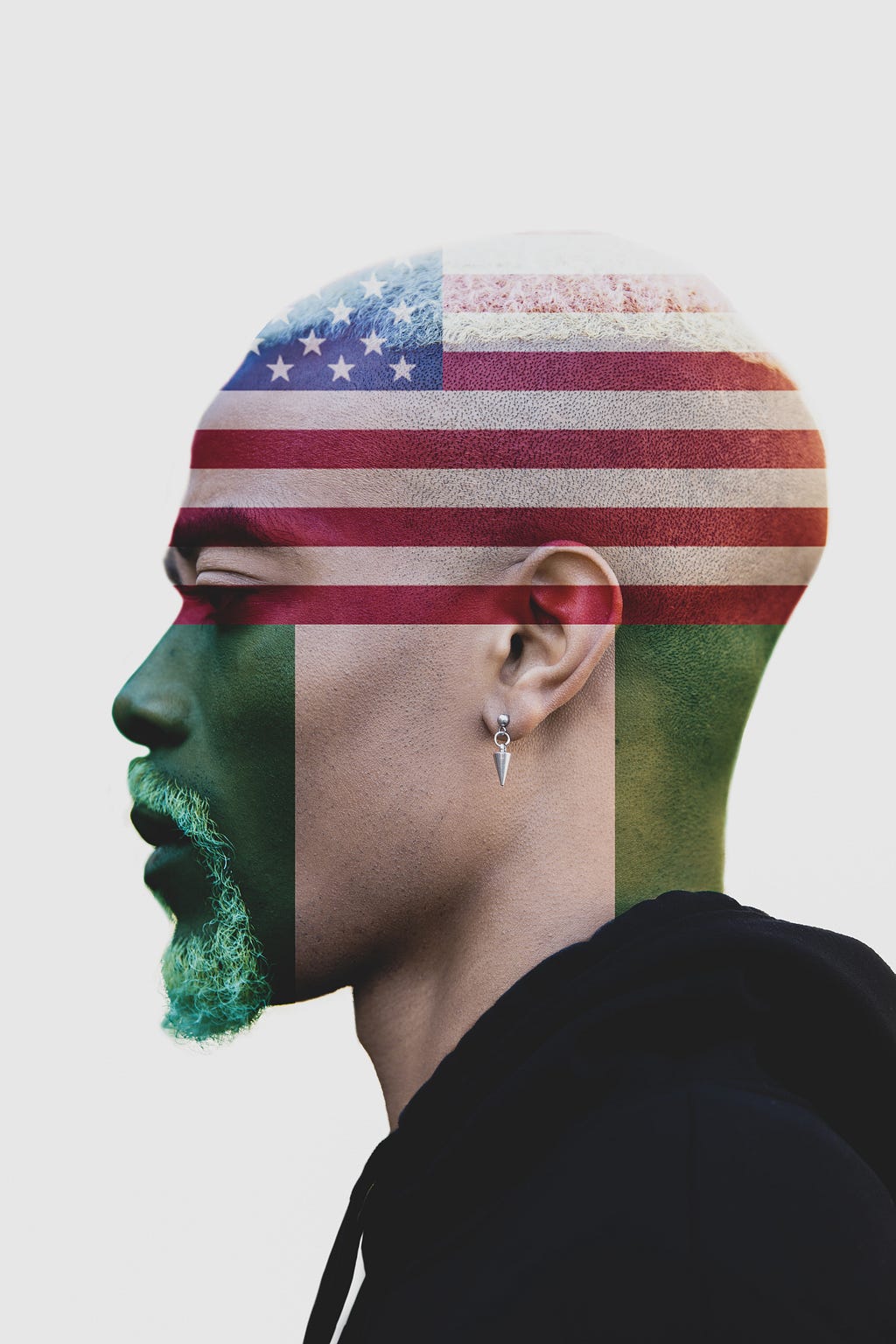 A portrait angle photo of me that has been edited so my face is 50% superimposed with the American flag and 50% the Nigerian.
