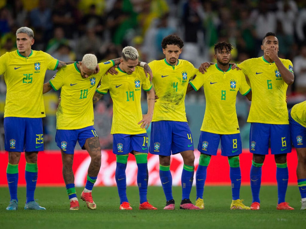 dejected Brazilian players following being knocked out on penalties