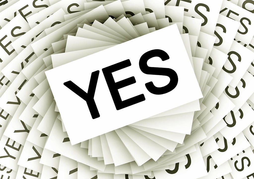 A stack of paper, each with the word YES typed on them.
