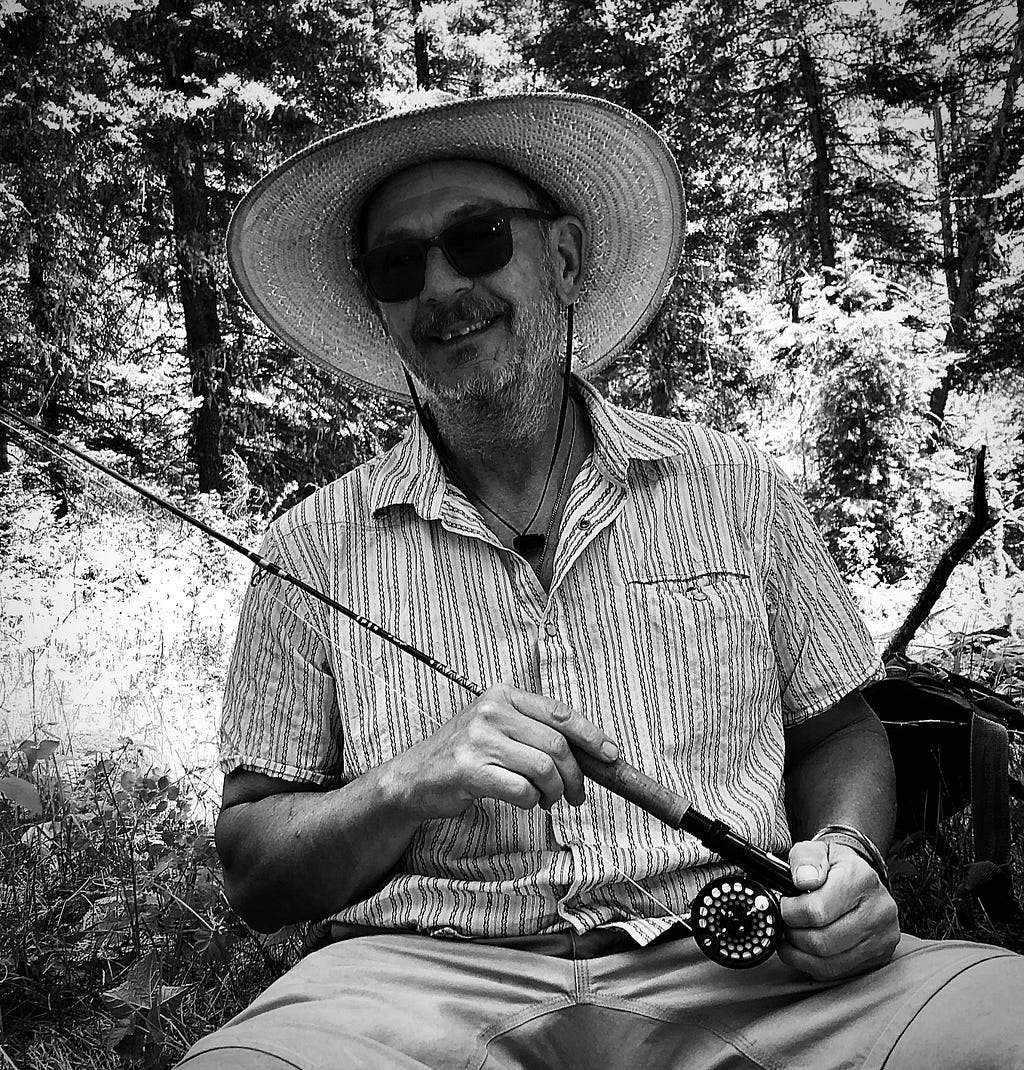 FWS author and photographer, Craig Springer, with a fishing rod in hand is in his natural element. Photo Courtesy of Craig Springer/USFWS.