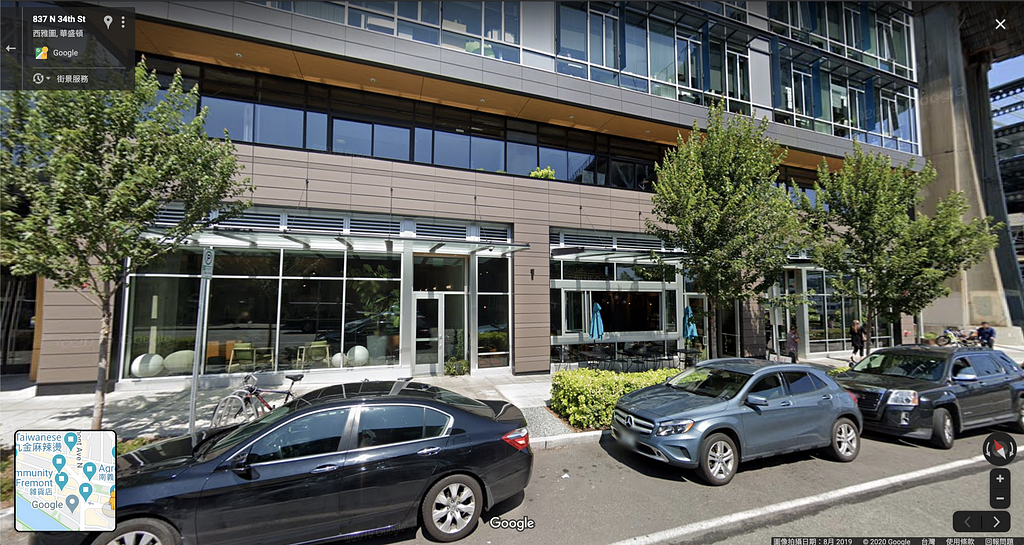 A screenshot of a building entrance blocked by trees on Google Street View