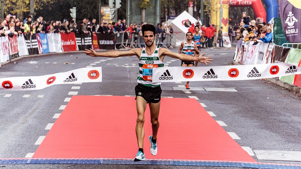 Image of runner crossing a finish line