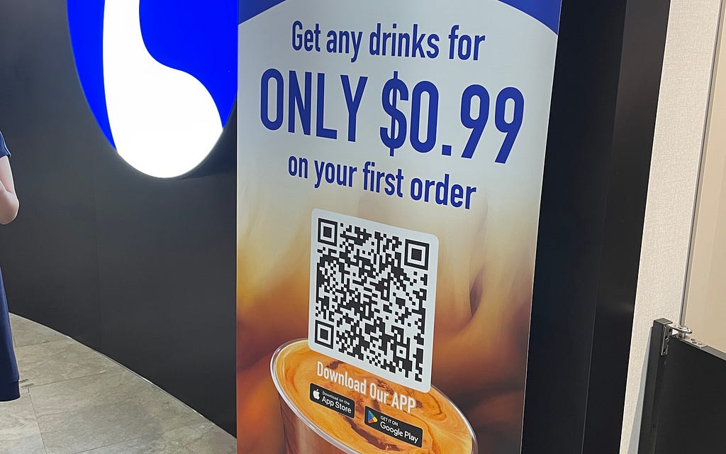 Picture of a pull-up screen with a 99 cent first time offer and a QR code that leads to a app download screen.