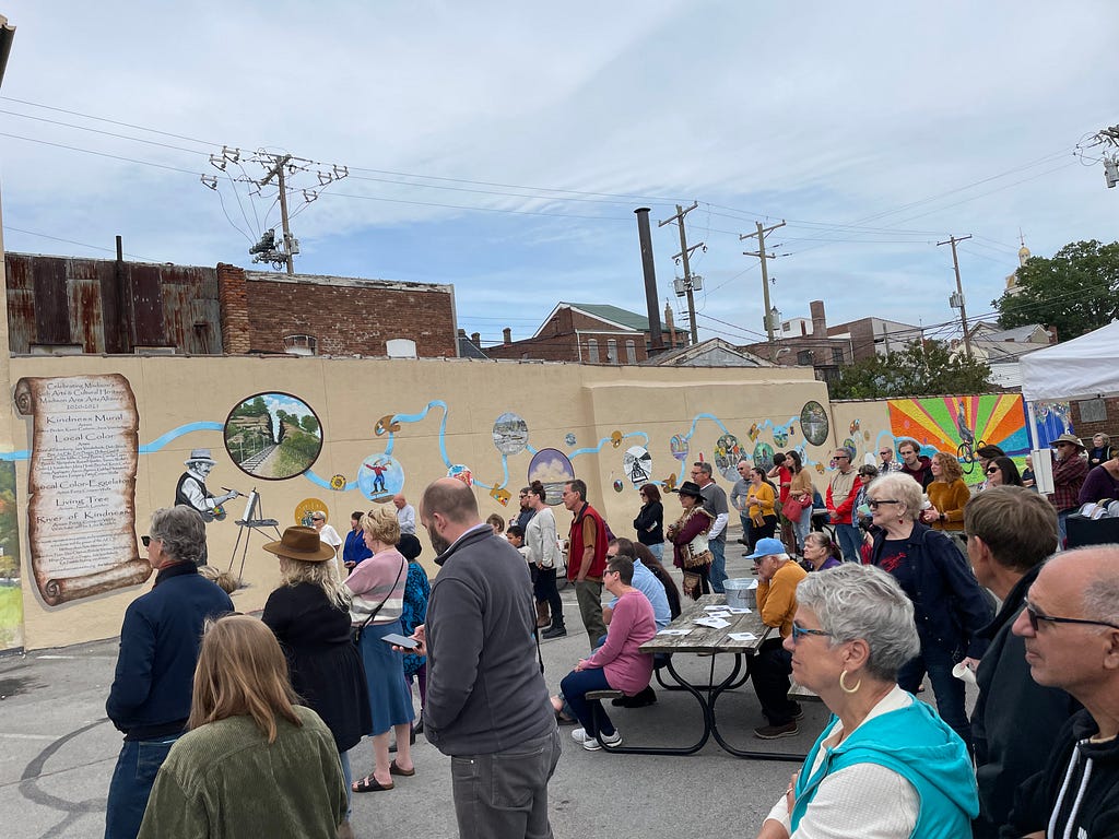 Community members stand at the unveiling of the mural.