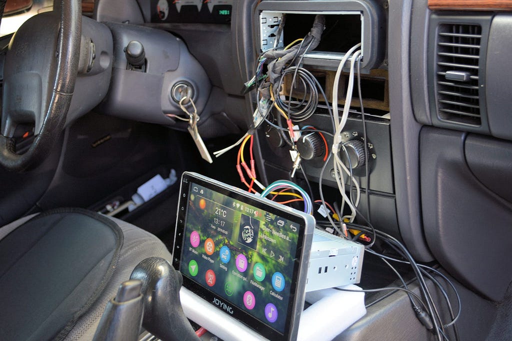 New touchscreen infotainment system being installed in a car dashboard.