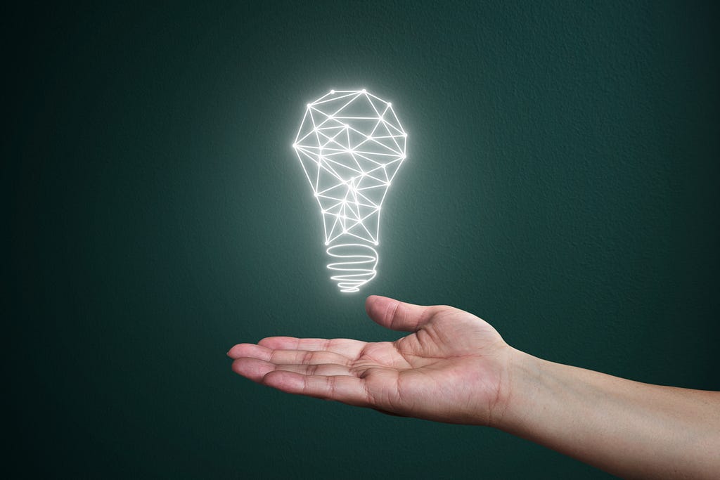 Hand holding a light bulb