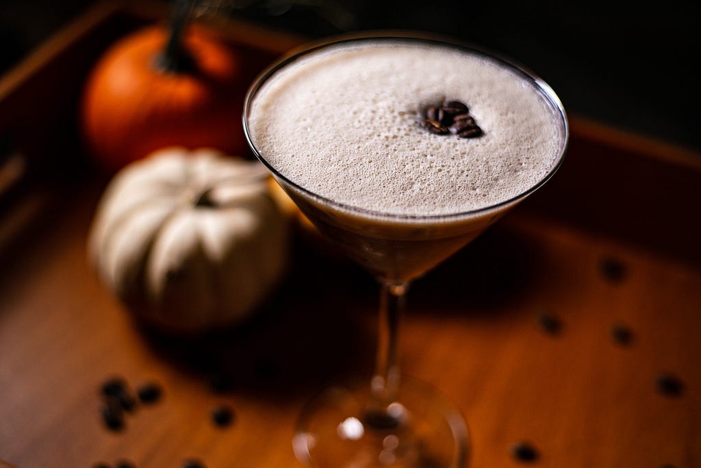 Espresso martini with gourds in the background