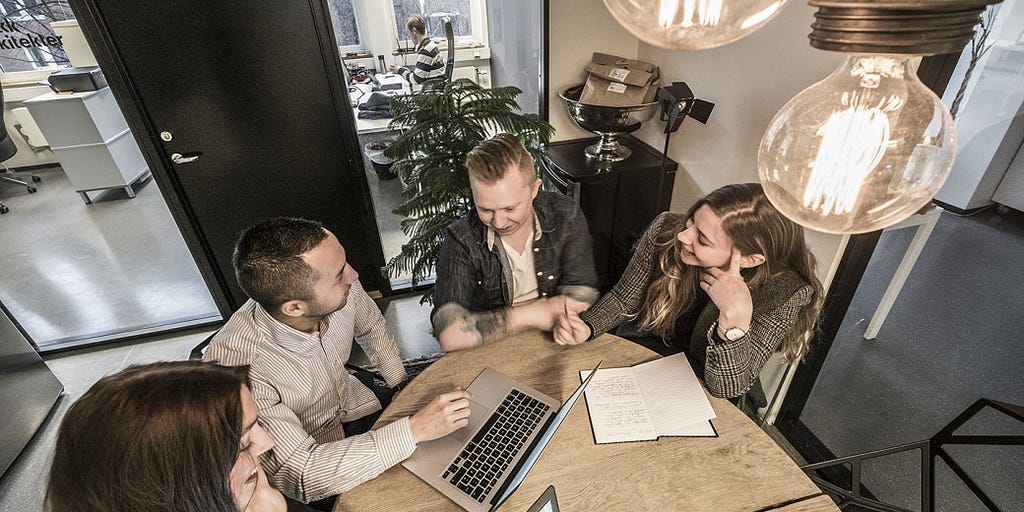 People round a table discussing