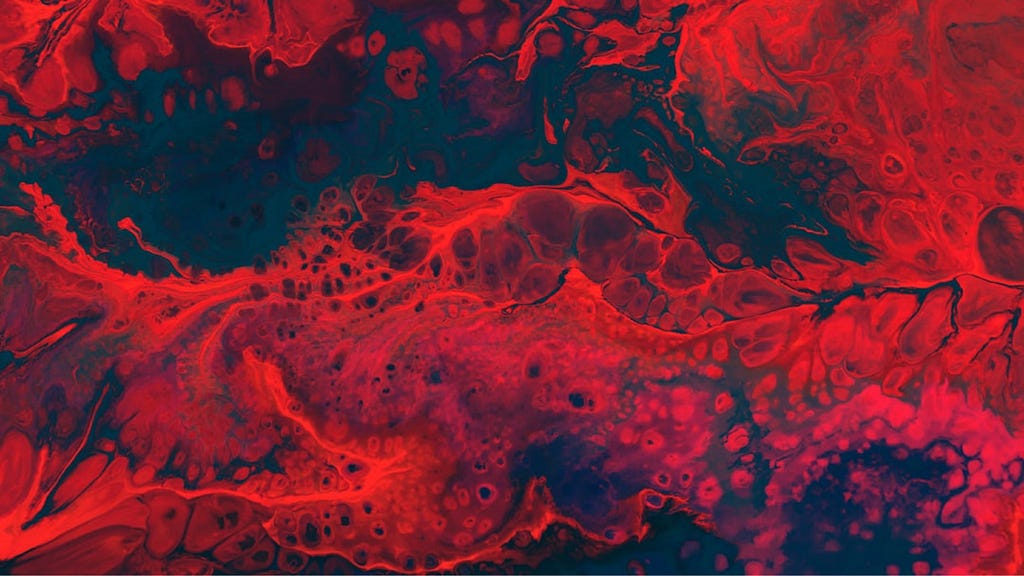 A stylized photograph of scarlet blood, splashing against a black background.