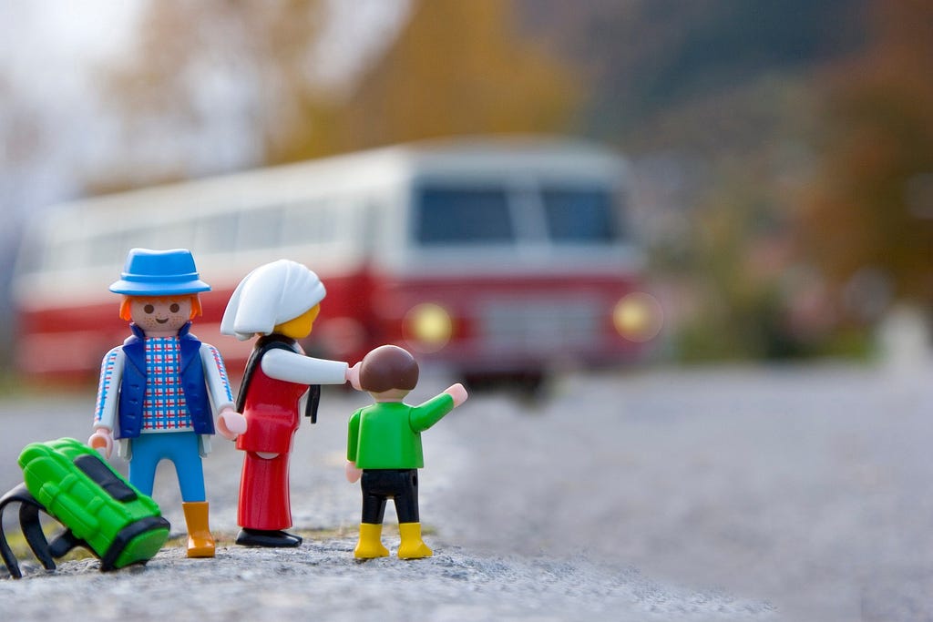 Photo of toy parents and child waiting for a bus