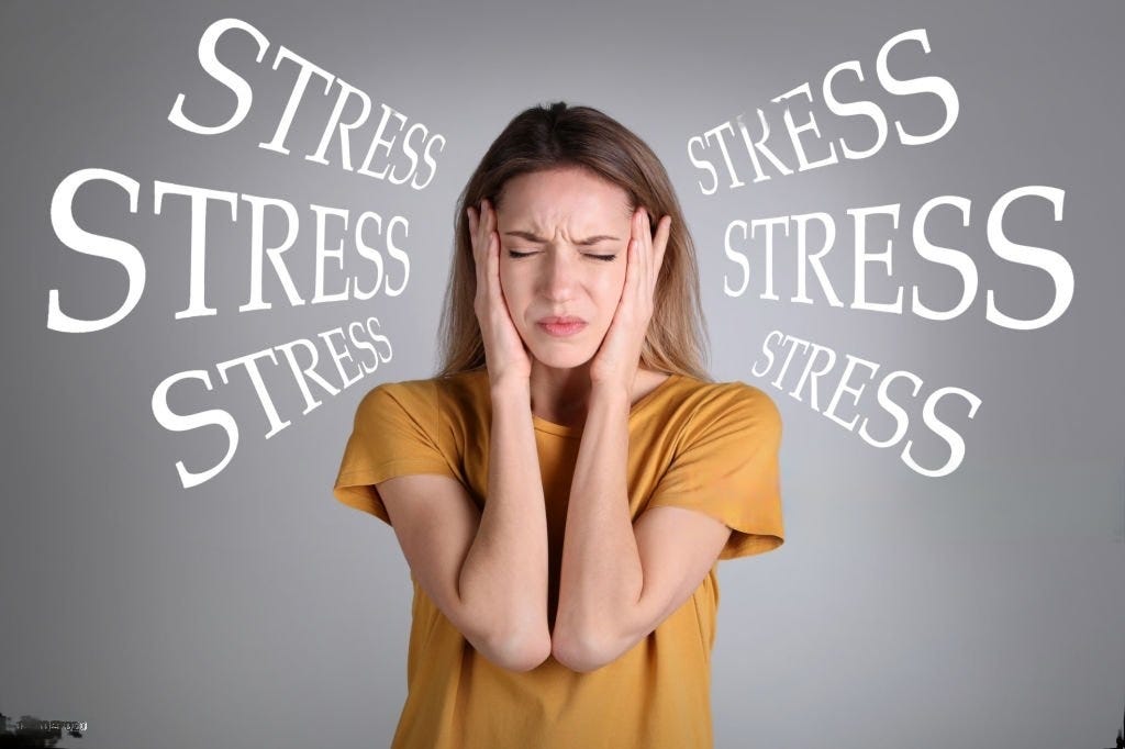 Image: A woman with her eyes closed, hands holding the forehead looking stressed due to ADHD