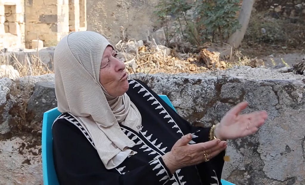 A woman talking to camera as part of an interview for the virtual tour of Umm Qais, exploring its history and hertiage.