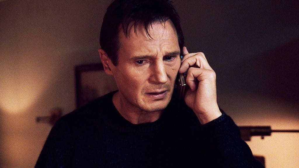 An image of Liam Neeson holding a phone in the film ‘Taken’