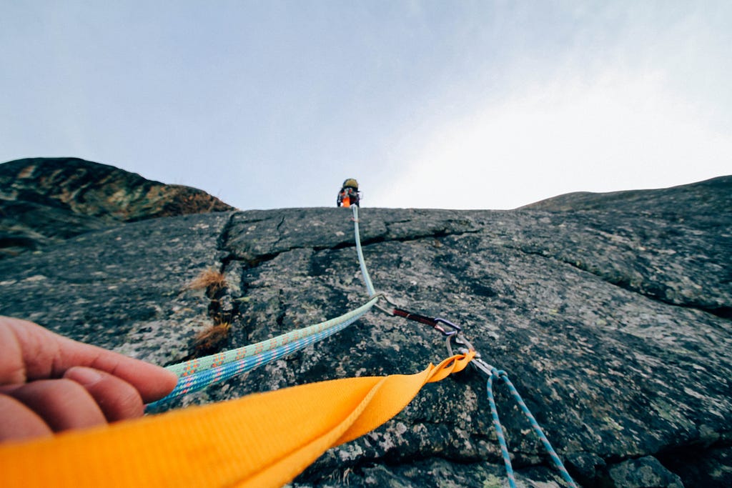 A hiker on his way to reach on the top of the hill illustrating the notion of traveling may play a big role in improving our adaptibility as it makes us face many challenges.