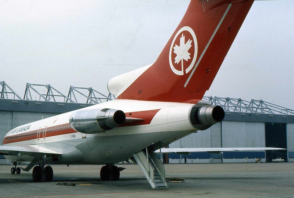 An Air Canada Boeing 727 jetliner with its rear ventral airstair deployed.
