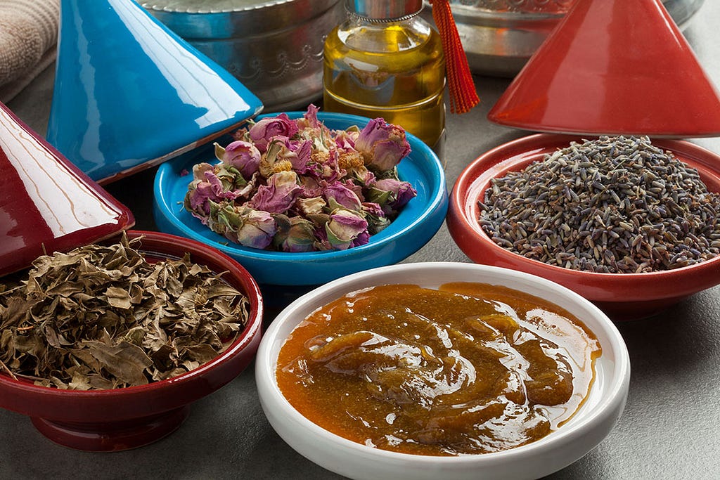 four bowls each containing a different moroccan spa essential