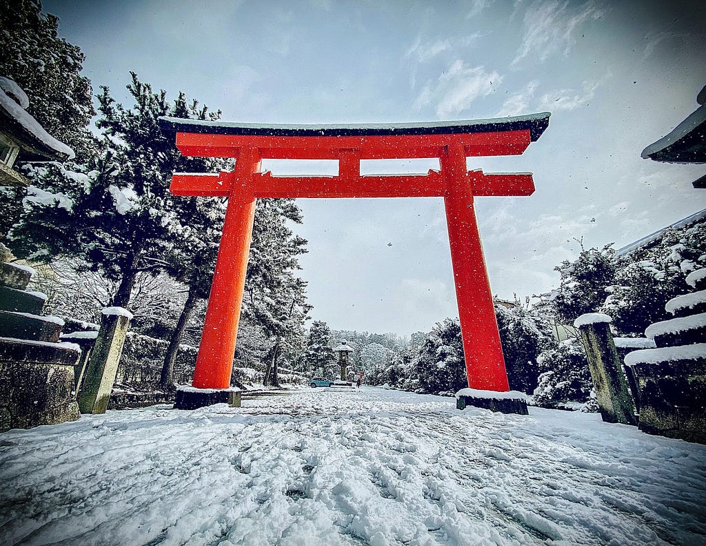 Main gate of a local Shinto shrine in Kyoto, Japan, on a snowy day