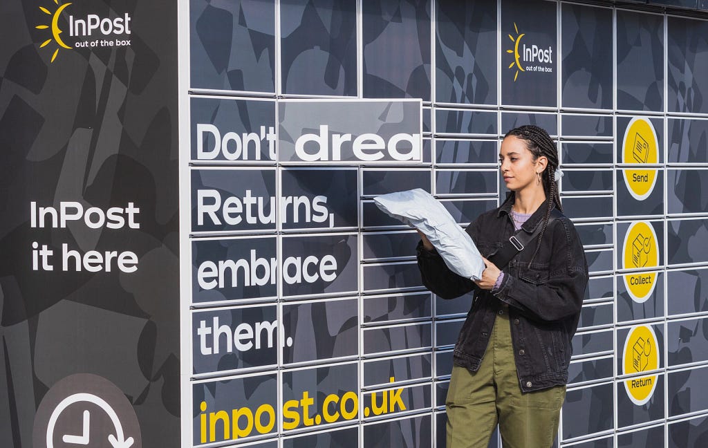 Woman with dreds putting parcel into an InPost Locker