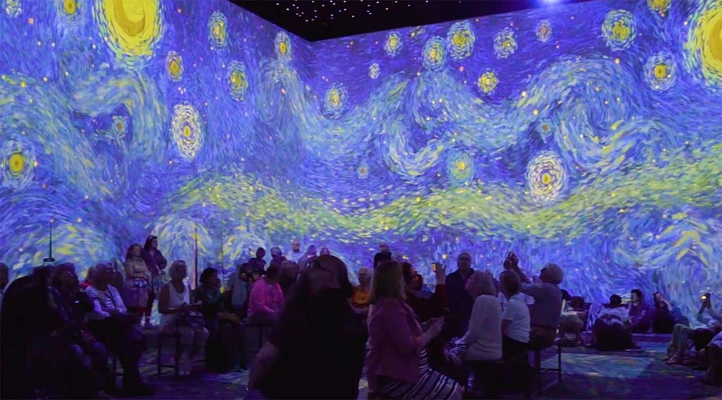 Starry background with a crowd of visitors from the Vincent Van Gogh immersive art exhibit