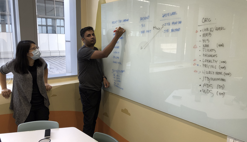 Designers Lynn Chen and Andre Rodrigues mapping out alternate Team setups in a whiteboarding session