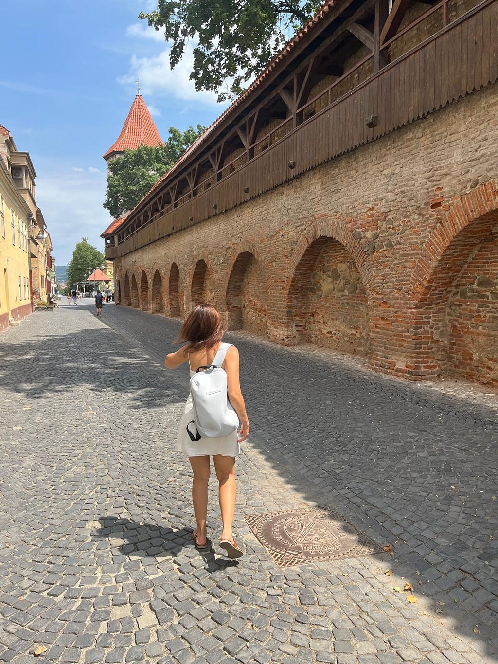 Girl walking in the summer on the streets of Sibiu Transylvania city.