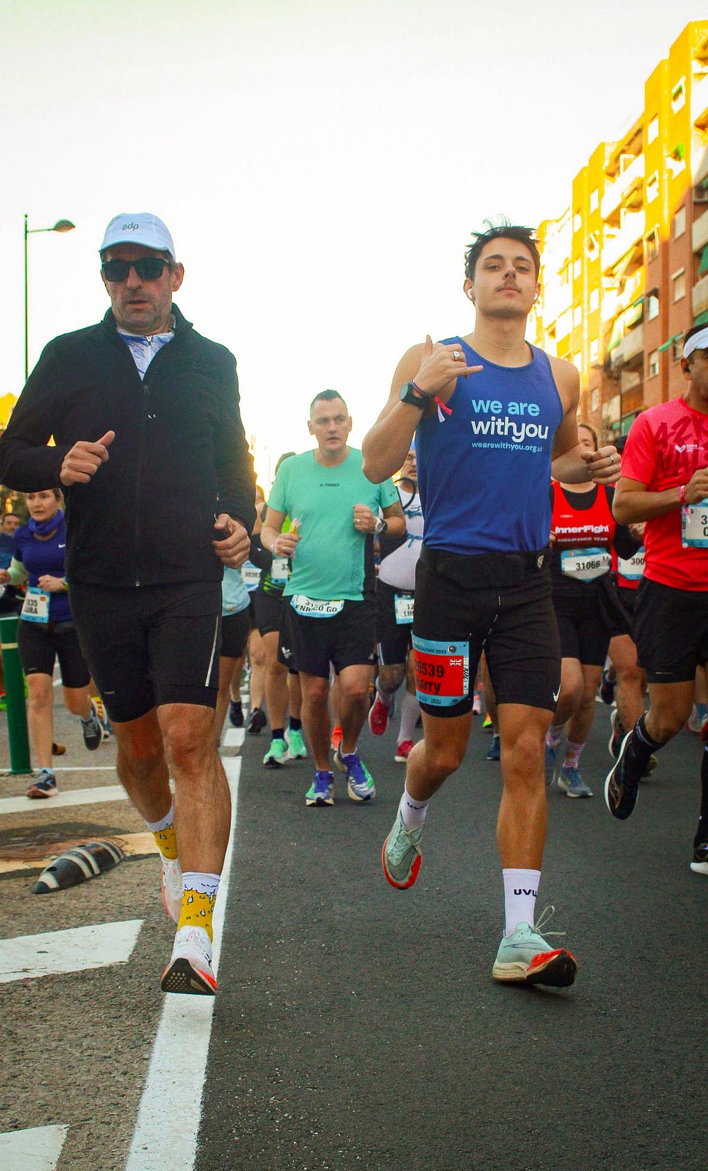 Harry, wearing a WeAreWithYou vest, running in a marathon.