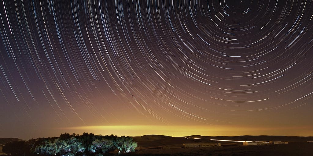 Stars going around the north star in a time lapse photo