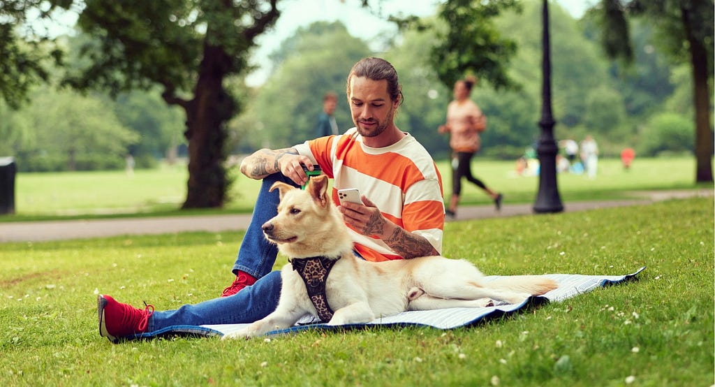 Man in the park holding a phone